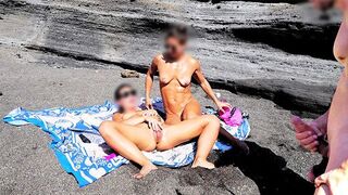 A girl removes her swimsuit and rubs herself on the beach