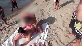 A towel spread on the beach, unbuttoned pants followed