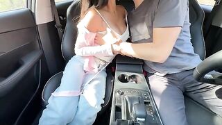 The girl is having fun with her friend in the back seat of his car