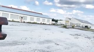 A girl is having fun in a unusual place with a big gun